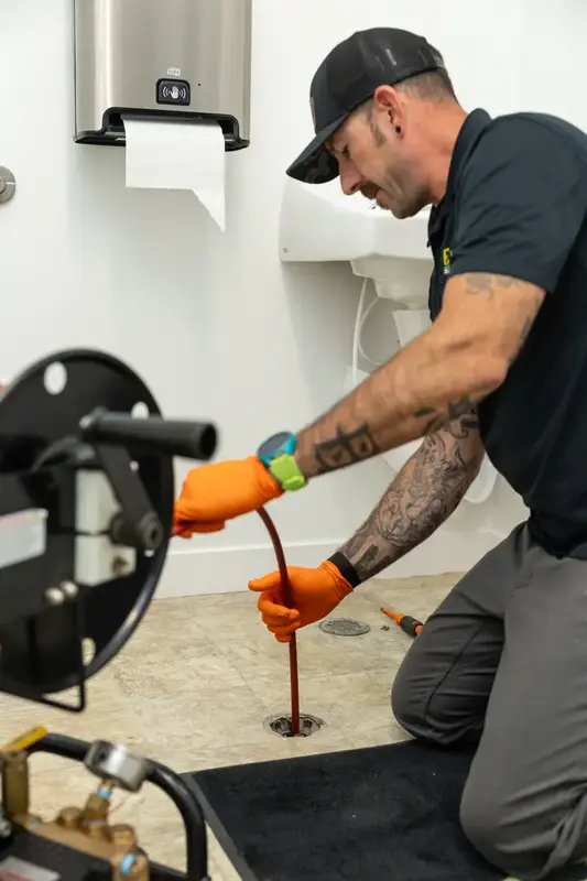 Element plumber clearing a floor drain in St. George, UT