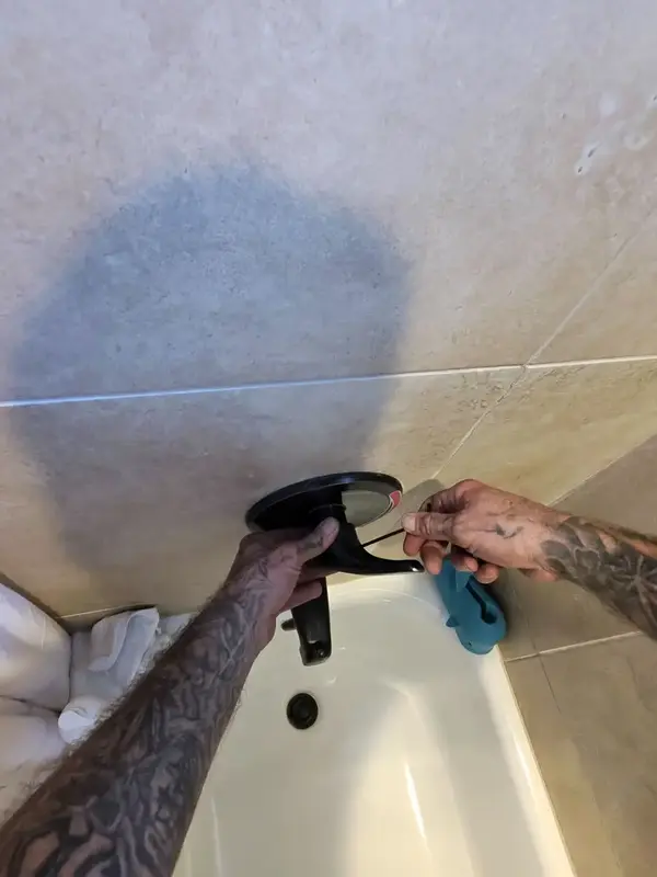 Element plumber repairing a leaking tub spout in St. George, UT