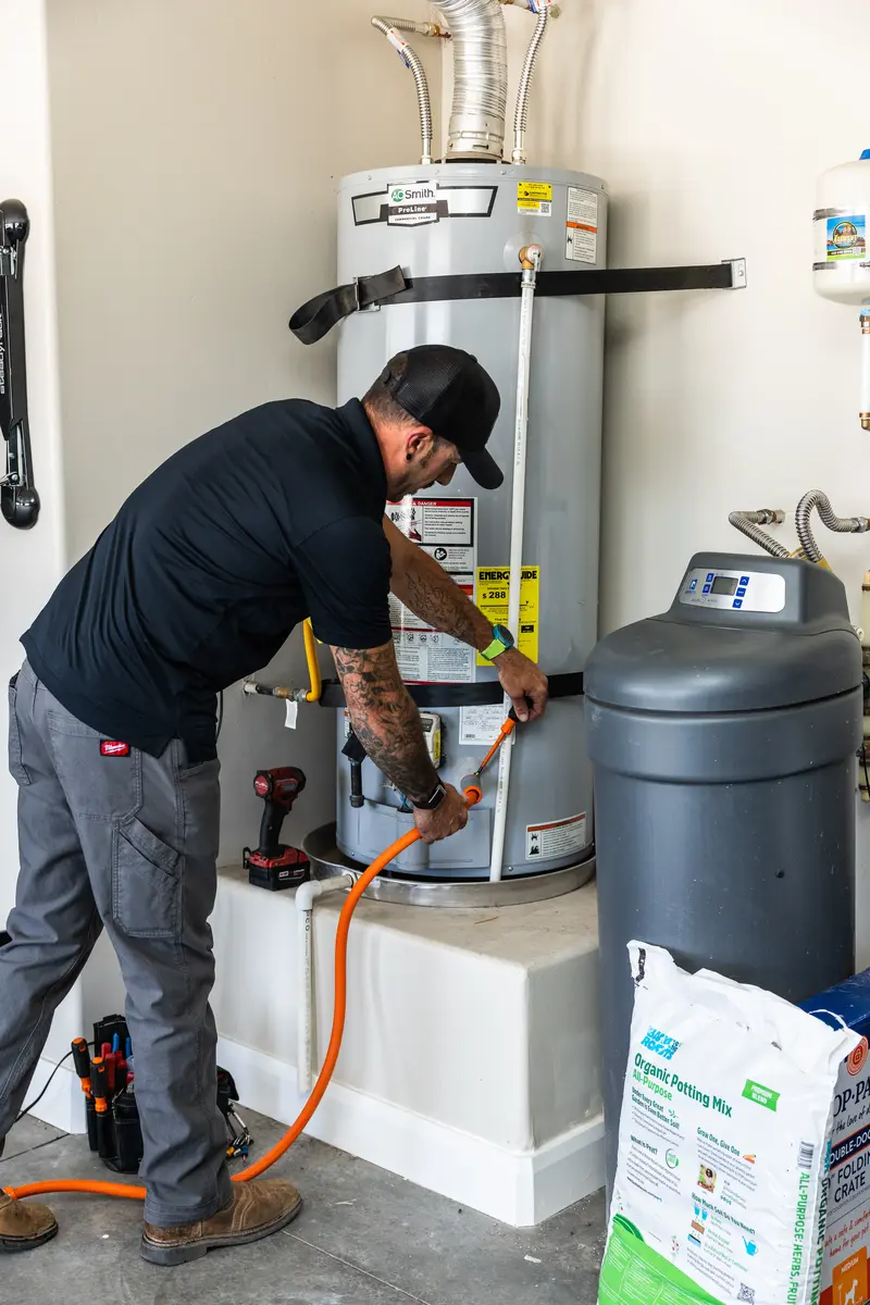 Element technician installing a water heater and softener in St. George, UT