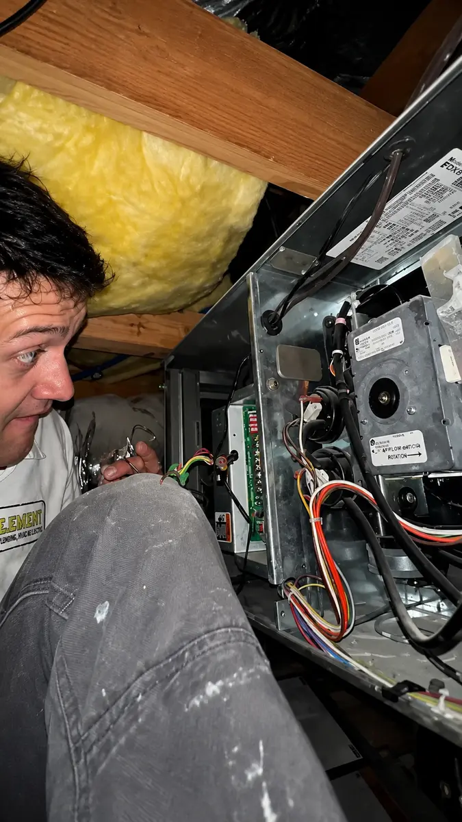 Element technician servicing a furnace in an attic in St. George, UT