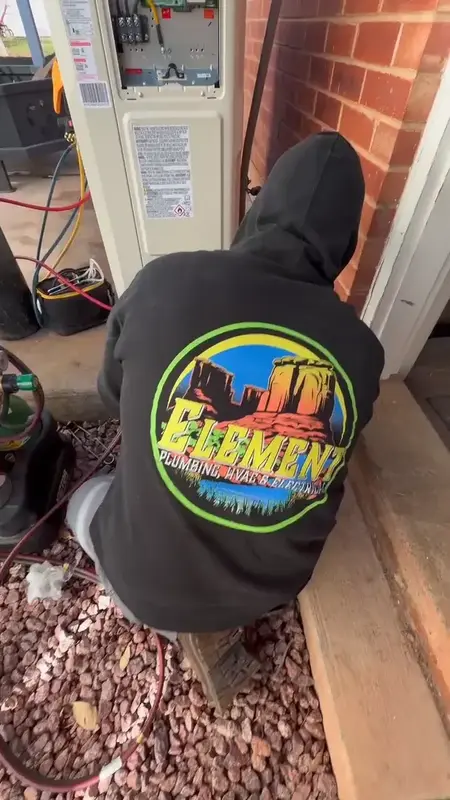 Element technician servicing a heat pump outdoor unit in St. George, UT