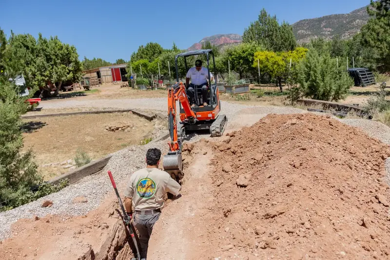 Excavator and crew at a water line job in St. George, UT