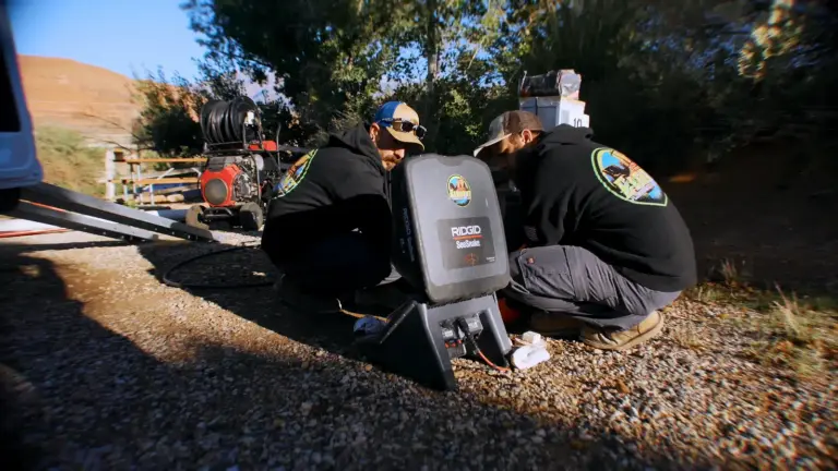 Two Element plumbers using an inspection camera outdoors in St. George, UT